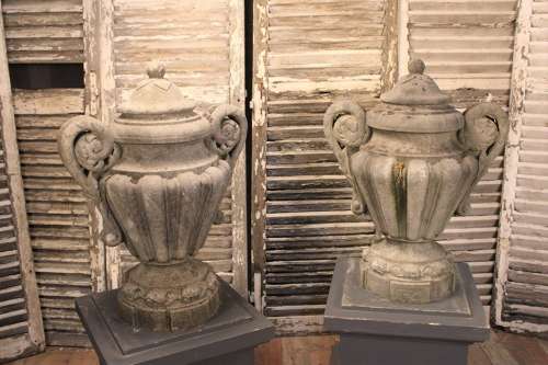 PAIR OF CARVED STONE LIDDED URNS
