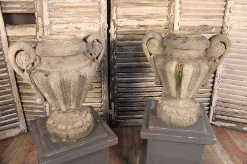 PAIR OF CARVED STONE LIDDED URNS