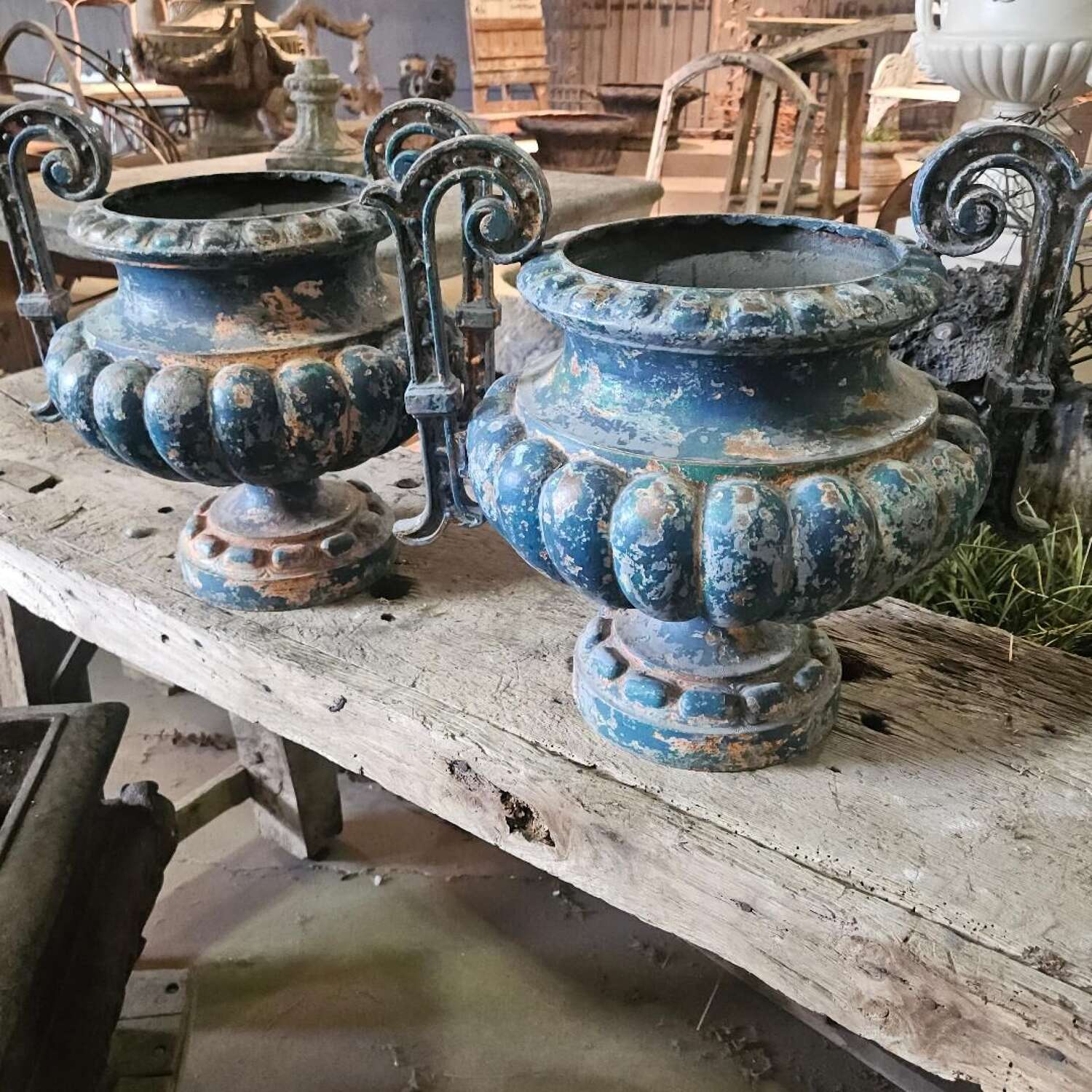 PAIR OF ALFRED CORNEAU CAST IRON URNS